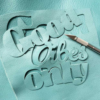 Good Vibes Only turquoise grained leather motif hand-sewn onto the front of the basket