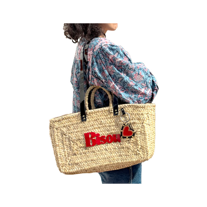 Straw basket with black leather shoulder handles