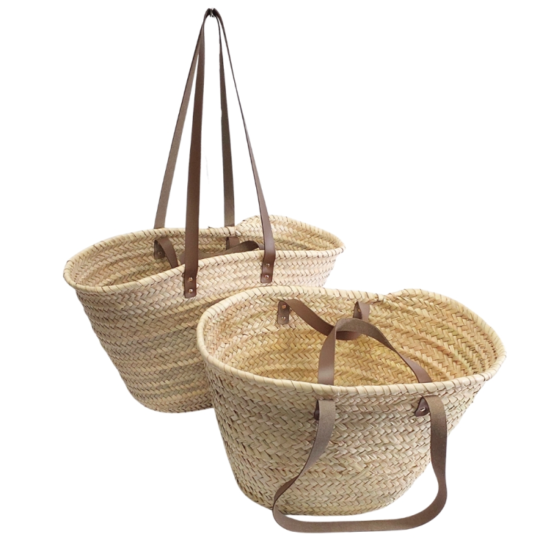 Handwoven natural beach basket with brown leather shoulder straps