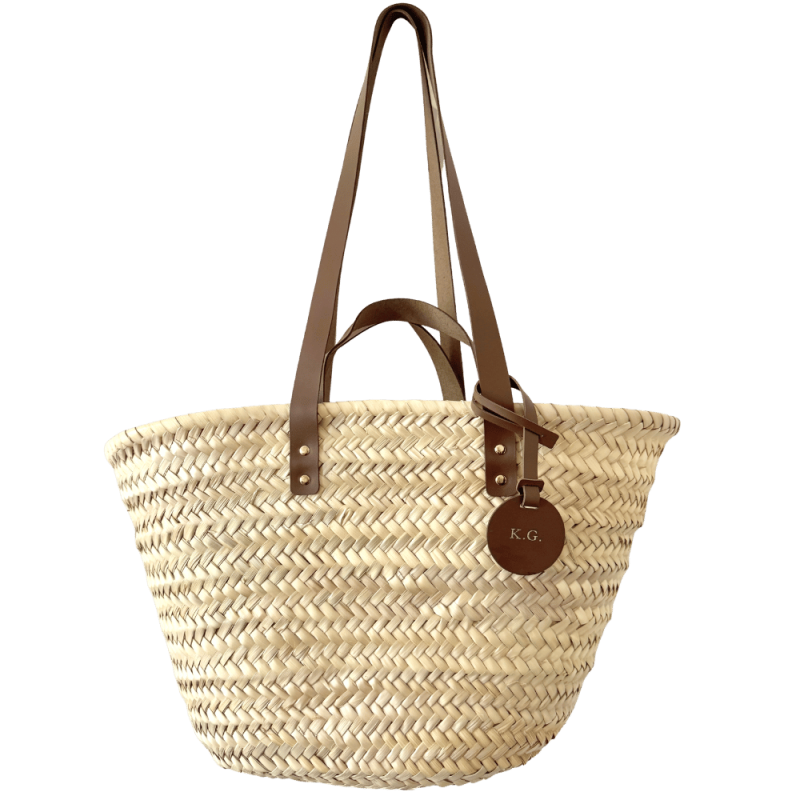 Personalized beach basket with brown leather handles and initials charm