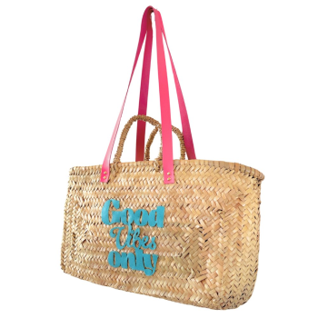 Bubblegum pink leather handles cut and applied by hand in the workshop on a Moroccan woven basket