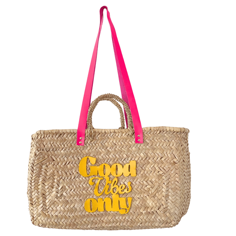 Rectangular palm leaf beach basket with fuchsia pink leather handles and yellow patent leather motif