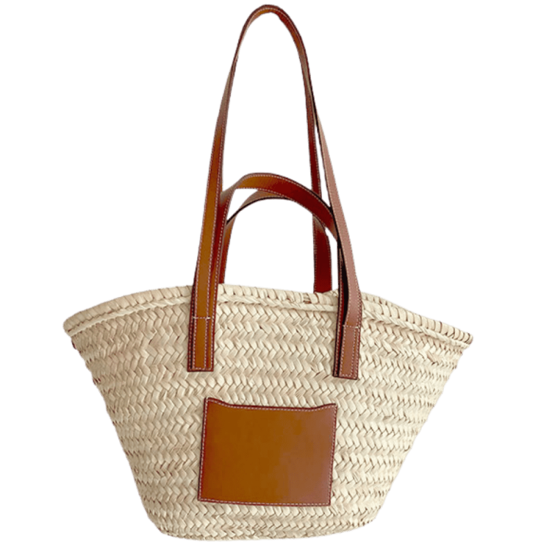Straw basket with camel leather handles worn on the shoulder