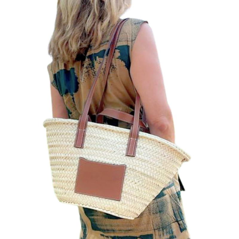 Genuine leather handles hand-stitched on straw basket