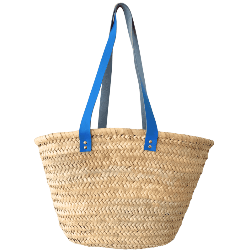 Large handcrafted straw basket with long bright blue leather shoulder handles