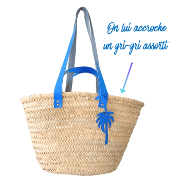 Straw basket with bright blue leather handles